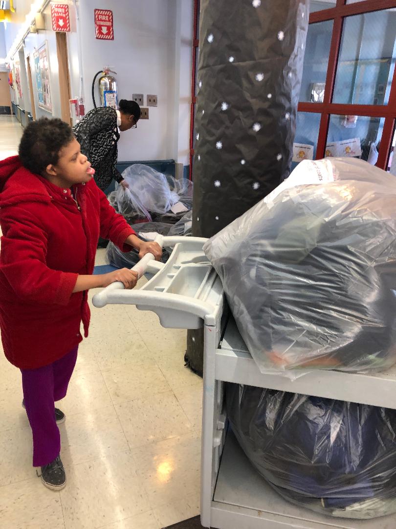 Student collecting coats for the coat drive.