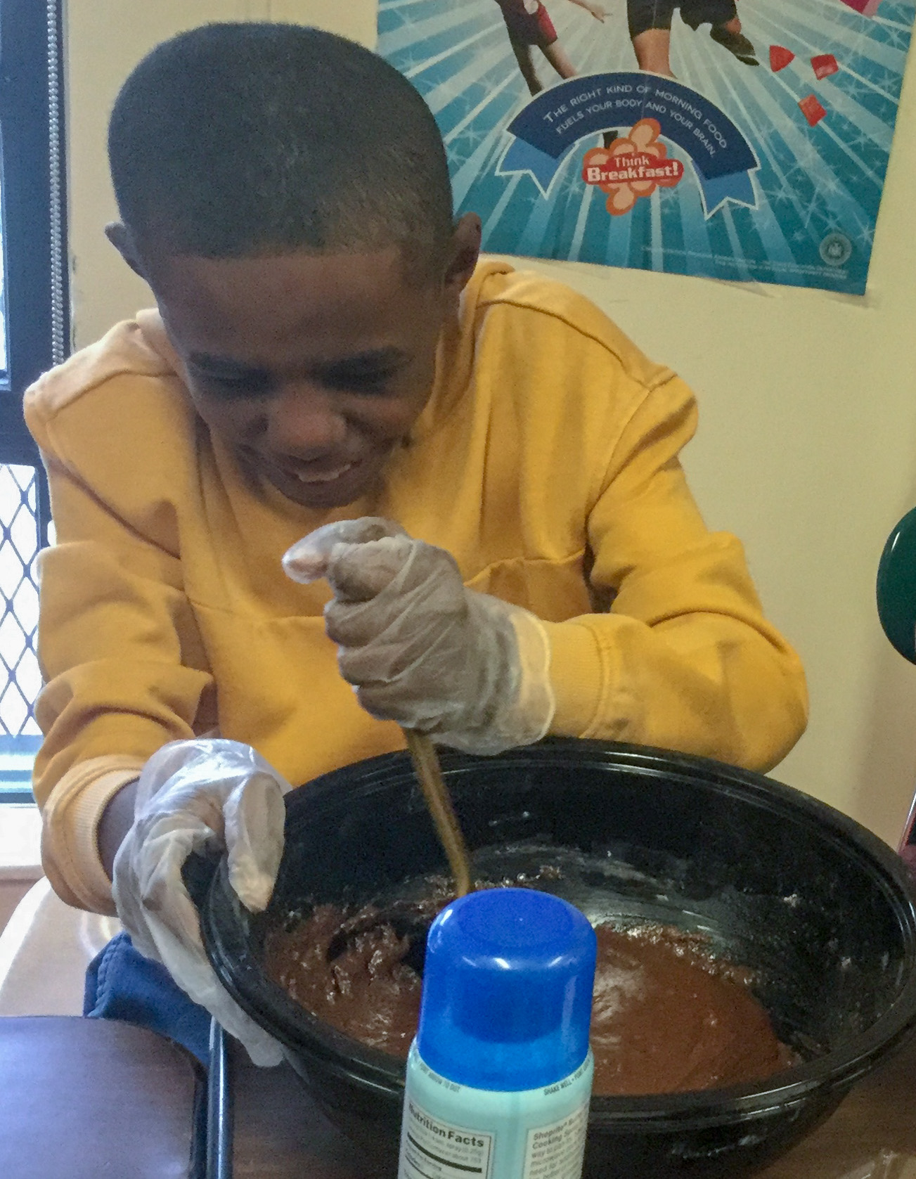 Student stirring during a cooking lesson.