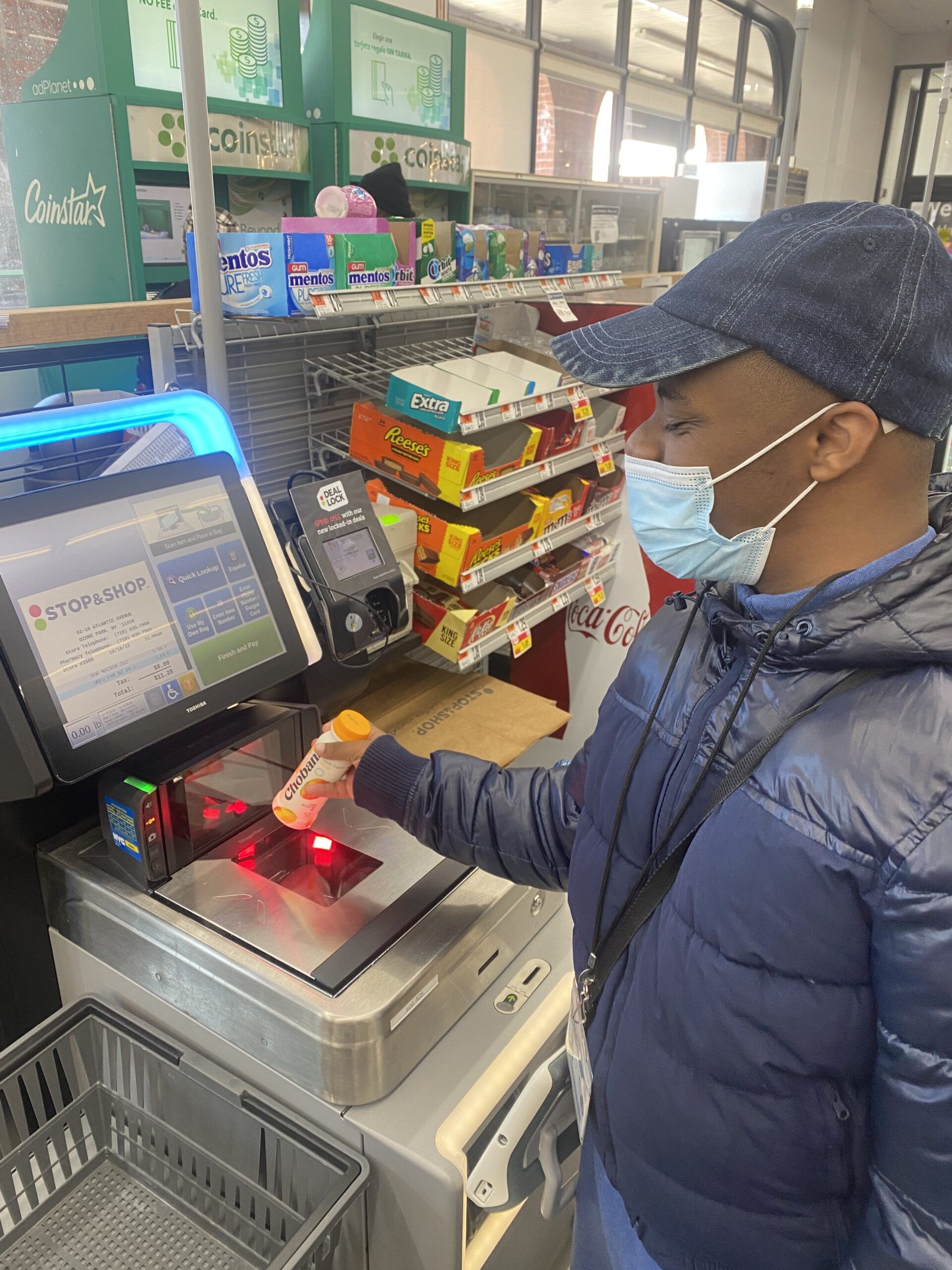 Student using a register to pay for a glue stick at a supermarket