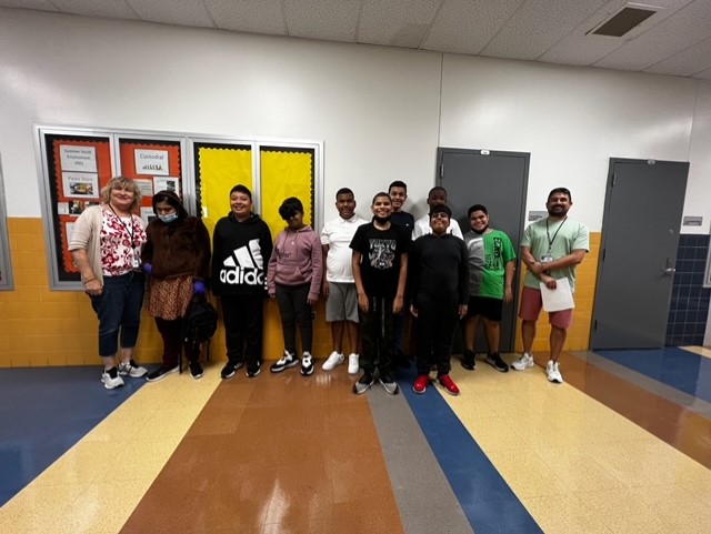 8 students and 3 teachers standing for a picture.