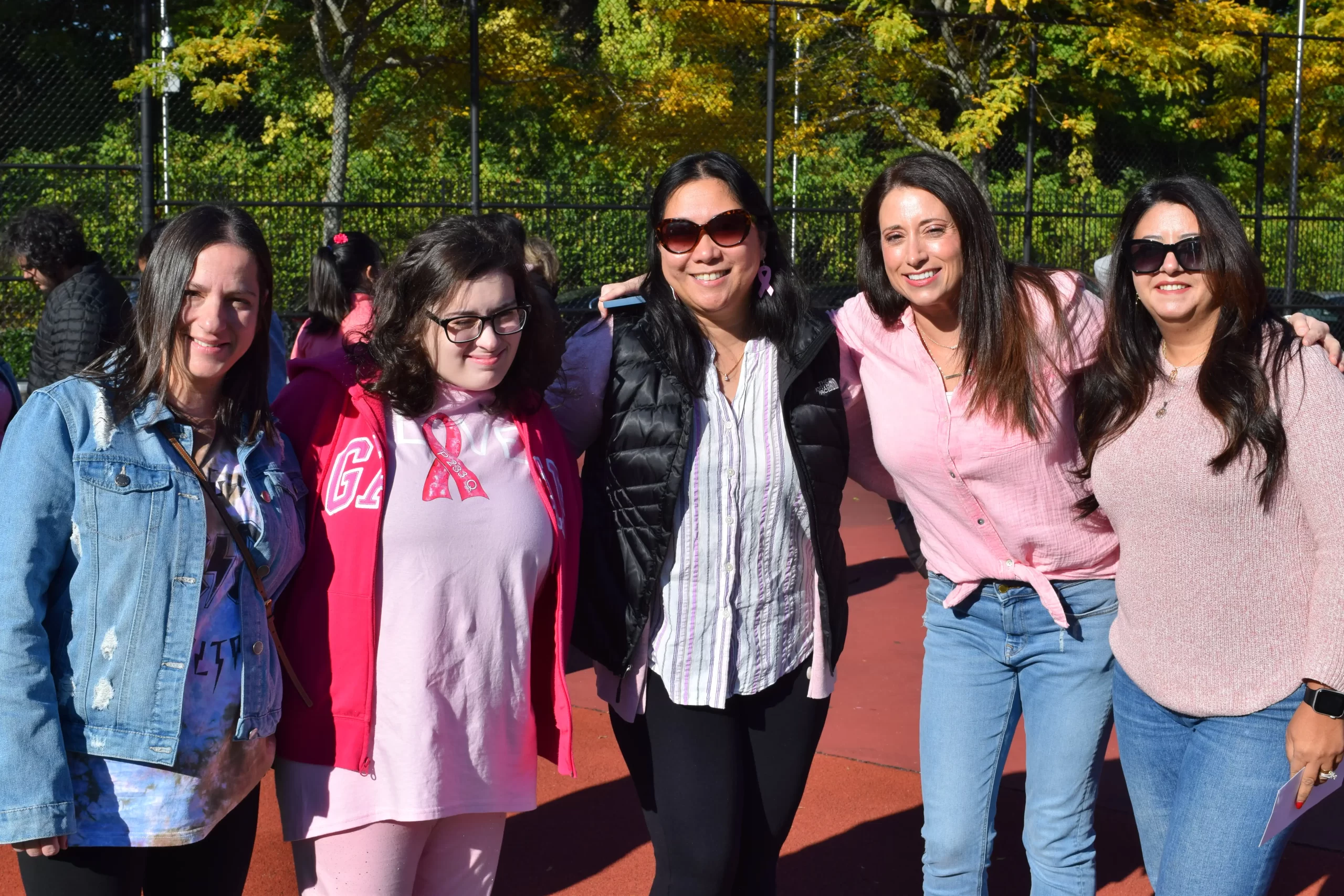 Student Kayla with her mom and teachers showing off their Pink shirts.