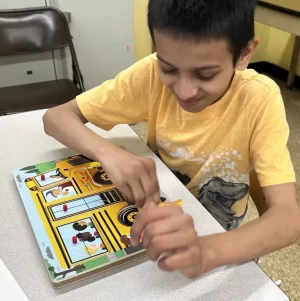 student solving a puzzle in the classroom