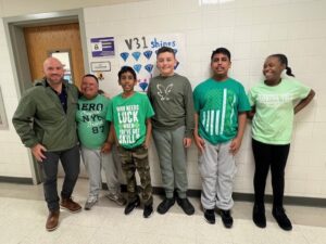 Four students wearing green