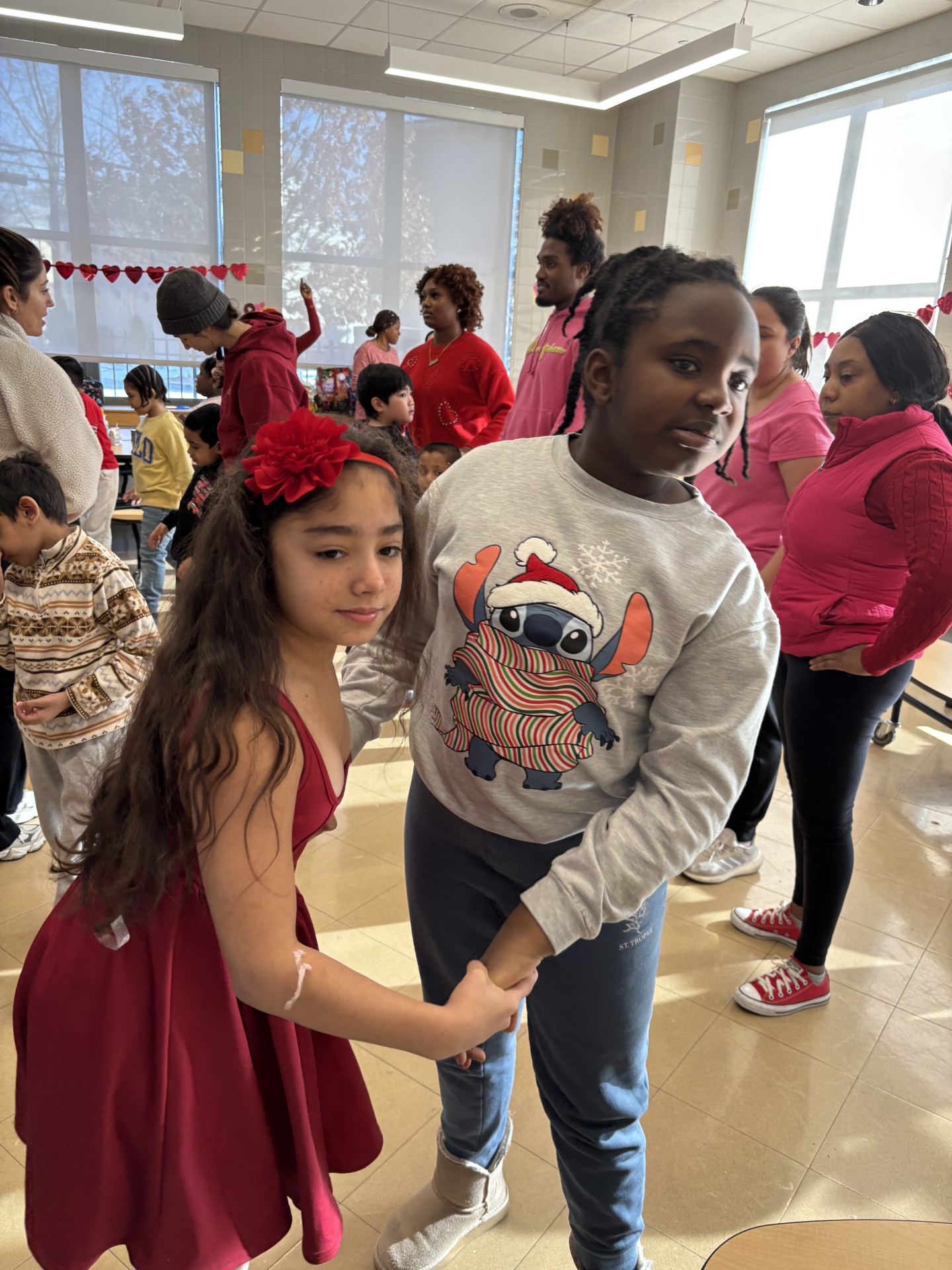 two students holding hands dancing