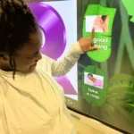 student pointing to a picture on a computer