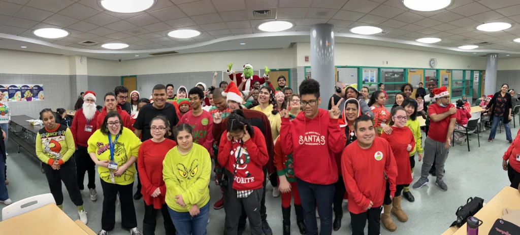 A large group of students dressed as Santa and the Grinch