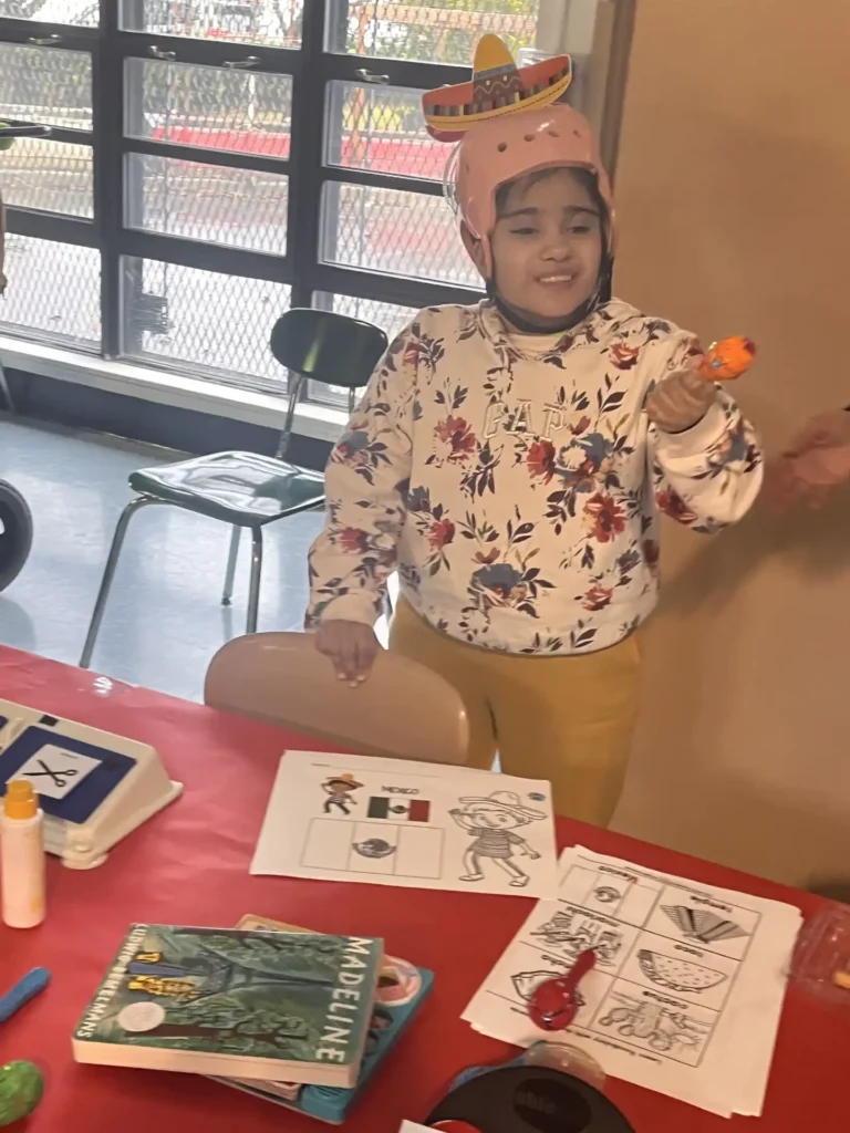 A teacher helping a student with their schoolwork at a desk