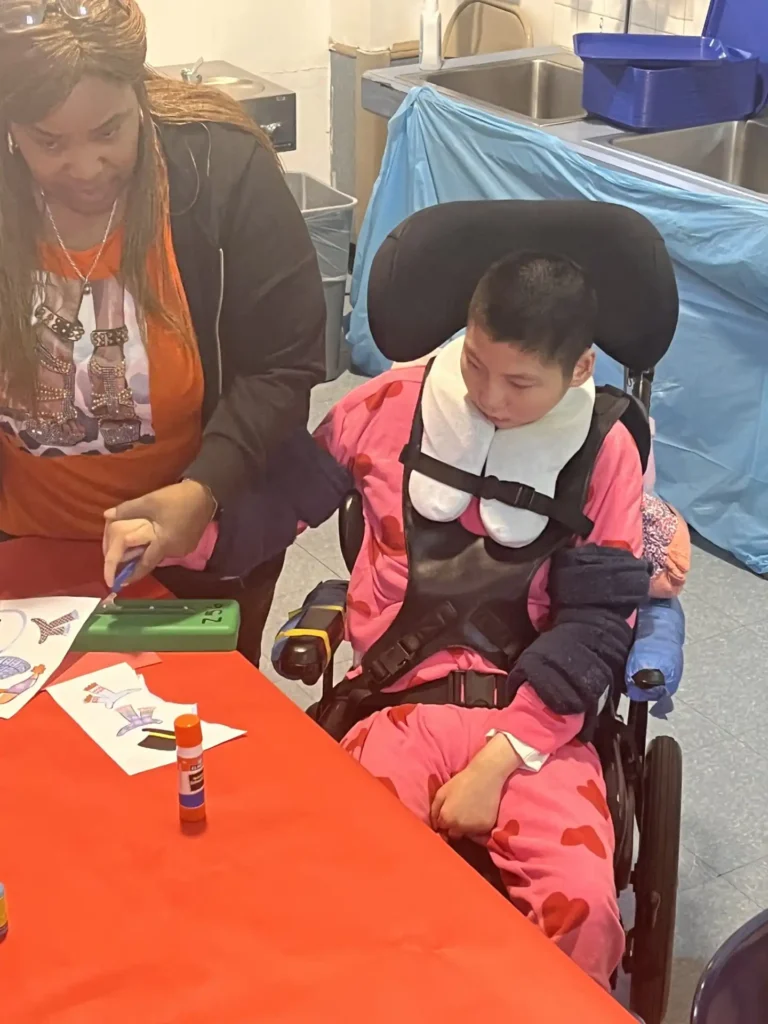 A teacher helping a student with their schoolwork at a desk