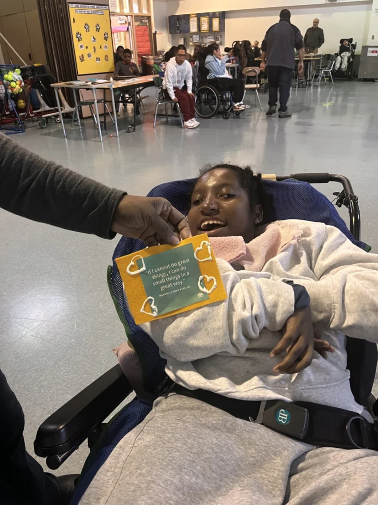 student holding a sign related to a reading