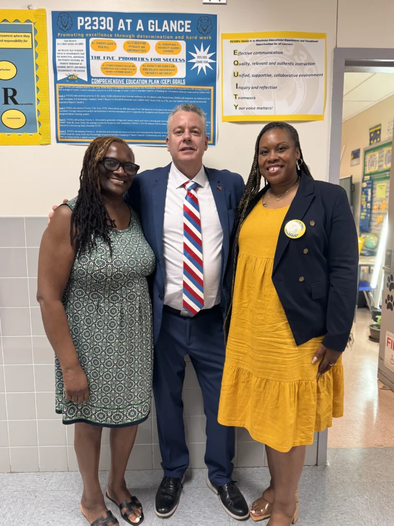 Deputy Superintendent Mr. McCormick with Leona Fowler and Debbie Edmonds Assistant Principal and Principal pose with Deputy Superintendent Mr. McCormick at a school event. Mr. McCormick is wearing a suit.